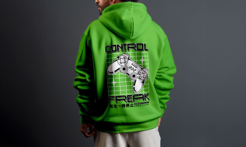 Man wearing green hoodie with "control freak" retro gamer graphic on back