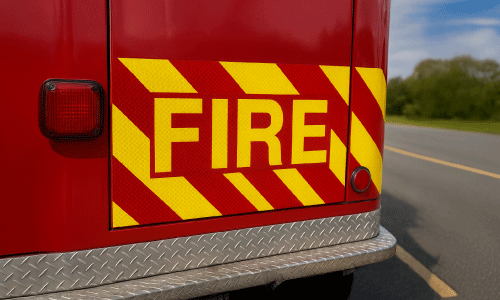 Reflective decal that reads "FIRE" placed on the back bumper of a fire truck